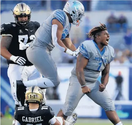  ?? PATRICK LANTRIP/AP ?? Memphis defensive lineman O'Bryan Goodson celebrates after sacking UCF quarterbac­k Dillon Gabriel on Saturday.