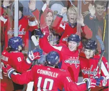  ?? AP PHOTO ?? PARTY TIME: The Capitals celebrate after Nicklas Backstrom scored in overtime to beat the Blues yesterday in Washington.