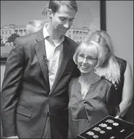  ?? Arkansas Democrat-Gazette/THOMAS METTHE ?? U.S. Sen. Tom Cotton hugs Charlotte Garlington after presenting her family with military medals for her father, George Anderson, at Cotton’s Little Rock office Wednesday. Anderson, a World War II veteran, died in 2006.