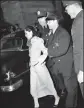  ?? AP PHOTO, FILE ?? Puerto Rican nationalis­t Lolita Lebron is led away by police officers following her arrest after a shooting attack on Capitol Hill in Washington, D.C., on March 1, 1954.