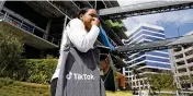  ?? DAMIAN DOVARGANES / ASSOCIATED PRESS ?? A TikTok Inc. employee walks outside the Chineseown­ed video-sharing company’s office in Culver City, Calif., on March 17.