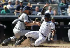  ?? JIM MCISAAC - THE ASSOCIATED PRESS ?? New York Yankees’ Aaron Hicks, right, is tagged out at the plate by Tampa Bay Rays catcher Erik Kratz ending the sixth inning of a baseball game, Saturday, May 18, 2019, in New York. Hicks tried to score from second base on a base hit by Gleyber Torres.