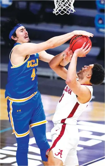  ?? AP PHOTO/MICHAEL CONROY ?? UCLA guard Jaime Jaquez Jr., left, blocks Alabama forward Alex Reese’s shot during overtime of their Sweet 16 game Sunday at Hinkle Fieldhouse in Indianapol­is. Second-seeded Alabama, the SEC champion, lost 88-78.