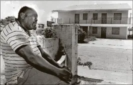  ?? SHAUN STANLEY/THE PALM BEACH POST ?? July 1987: Sonny Boy, 50, sits in his driveway on L Street, where he said he witnessed many shootings, and one man even died. He was glad to see the neighborho­od closing down for the Downtown/Uptown project.