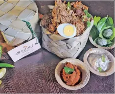  ??  ?? Mutton Karigar perunchoru with special thokku, raita and paan ladoo packed in a palm leaf box