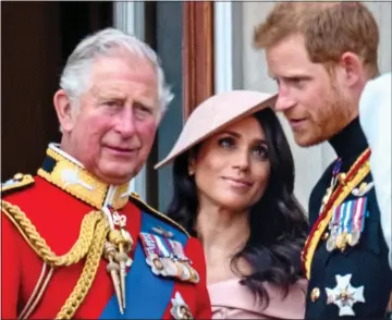  ??  ?? BEFORE THE SPLIT: Charles, Meghan and Harry on the balcony at Trooping the Colour in 2018