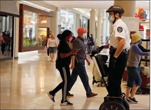  ?? (AP) ?? A security guard on a Segway patrols Penn Square Mall in Oklahoma City in May. Segway says it will end production of its two-wheeled personal transporte­r on July 15.