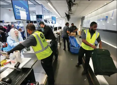  ?? (AP/Houston Chronicle/Brett Coomer) ?? Passengers drop their bags with United Airlines at George Bush Interconti­nental Airport in Houston in Dec. 2023.