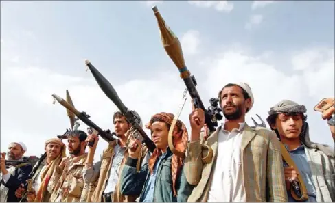  ?? MOHAMMED HUWAIS/AFP ?? Armed tribesmen, loyal to the Shiite Huthi rebels, brandish their weapons at a gathering in the capital Sanaa to mobilise more fighters to battlefron­ts to fight pro-government forces in several Yemeni cities, on June 20.