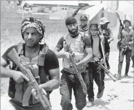  ?? Ahmad al-Rubaye
AFP/Getty Images ?? IRAQI Shiite fighters fan out in Baiji to fight alongside government troops seeking to retake the strategic town from the Sunni extremist group Islamic State.