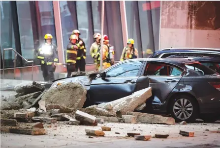  ?? The Canadian Press ?? Firefighte­rs arrive after an undergroun­d explosion occurred near the entrance to a building that makes up the Vancouver House condo, retail and office developmen­t, Tuesday.