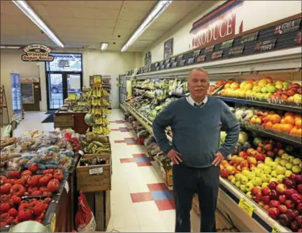  ?? BEN LAMBERT — THE REGISTER CITIZEN ?? John Dwan, standing inside his store, the IGA Winsted Super Saver on Main Street, Winsted, wants to sell his property to Community Health & Wellness of Greater Torrington, and will retire after 36 years.