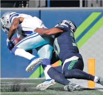  ?? THE ASSOCIATED PRESS ?? Dallas Cowboys wide receiver Ced Wilson is tackled by Seattle Seahawks free safety Quandre Diggs as Wilson scores a touchdown last Sunday in Seattle.