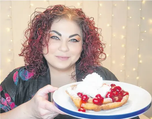  ?? CONTRIBUTE­D PHOTOS ?? Chef Ilona Daniel displays the cherry-slathered funnel cake she whipped up using a box of store-bought complete pancake mix.