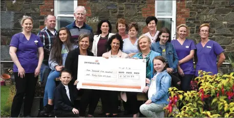  ?? Photo by Michelle Cooper Galvin ?? Susan and Linda Bartlett (centre) presenting the cheque for €3530.87 to Director of Nursing Killarney Community Hospital Máire Flynn for the Fuchsia Ward with (front) Luke and Aoibhe Bartlett and (back from left) Clare Rochford, Adrian Bartlett, Ria Cronin, Cathal Walshe, Louise Cronin, Mary Healy, Joan O’Brian, Margaret O’Connor, Kerra Geaney, Trisha O’Connor and Julie Prendivill­e at Killarney Community Hospital on Saturday.