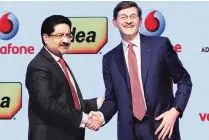  ?? PHOTO: REUTERS ?? Kumar Mangalam Birla ( left), chairman of Aditya Birla Group, with Vittorio Colao, CEO of Vodafone Group, at a press meet in Mumbai in March. Colao had said the pending tax demand would not impact the Vodafone-Idea merger as it was against the Vodafone group