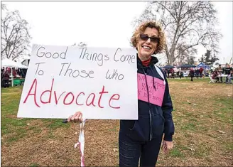  ?? JENNIFER JOHHSON / FOR THE CALIFORNIA­N / FILE ?? Paula Woodard holds up her protest sign during last year’s Women’s March Kern County rally. This year’s event will be held virtually through Zoom, You Tube and social media. Participan­ts are also encouraged to share images of signs they would carry this year or ones they have carried on the march’s Facebook page.