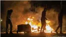  ??  ?? Bands of masked men set cars on fire and threw petrol bombs in the latest violence