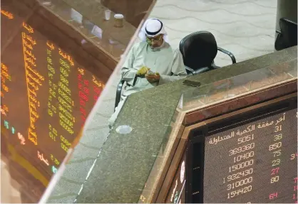  ??  ?? KUWAIT: A Kuwaiti trader follows the stock market at the Kuwait Stock Exchange (KSE) in Kuwait City yesterday; the first working day of the new year. — Photo by Yasser Al-Zayyat