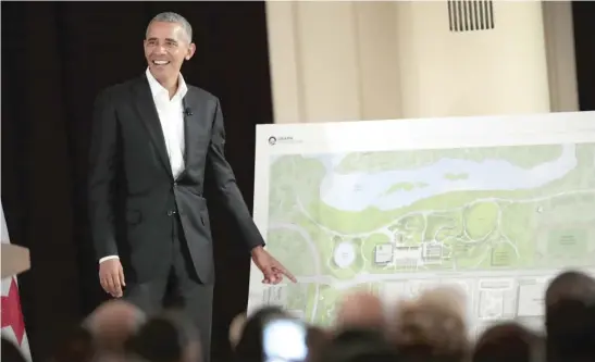  ?? SCOTT OLSON/GETTY IMAGES ?? Former President Barack Obama points out features of the proposed Obama Presidenti­al Center, which is scheduled to be built in nearby Jackson Park, during a gathering at the South Shore Cultural Center in May 2017.