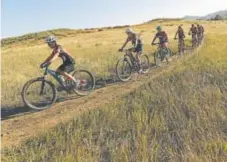  ?? Helen H. Richardson, The Denver Post ?? Members of the Golden High School cycling team head out on a trail on South Table Mountain for a training ride on Thursday.