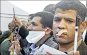  ?? AMR NABIL / ASSOCIATED PRESS ?? Egyptian journalist­s tape their mouths and raise their pens during a demonstrat­ion against the draft constituti­on in Cairo on Sunday.