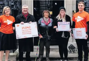  ??  ?? ●●MP Tony Lloyd joins the MS society outside 10 Downing Street to deliver the letter