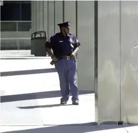  ?? Ken Blaze/News-Herald ?? A security oficer walks the grounds of the Federal Building Tuesday afternoon in downtown Cleveland after two planes destroyed the World Trade Center in New York.