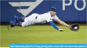  ??  ?? NEW YORK: Brandon Nimmo #9 of the New York Mets makes a diving catch in the second inning against the Cincinnati Reds at Citi Field on August 7, 2018. — AFP