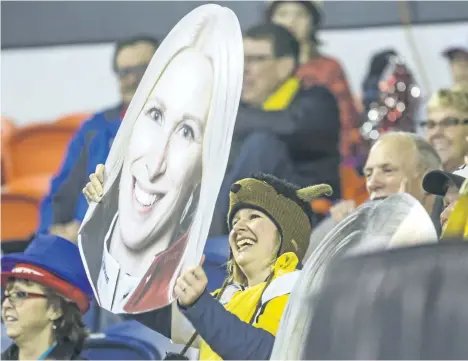  ?? BOB TYMCZYSZYN/POSTMEDIA NETWORK ?? Manitoba supporters sport large cutouts during the Scotties Tournament of Hearts at Meridian Centre in St. Catharines on Wednesday. Fans aren’t shy about displaying their love of the sport and their home-province teams.