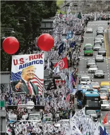  ?? Ahn Young-joon / Associated Press ?? Protesters march Saturday after a rally to welcome a planned visit by President Donald Trump in Seoul.