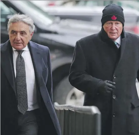  ?? GAVIN YOUNG ?? Robin Camp, right, walks with his lawyer Alain Hepner Tuesday into a reinstatem­ent hearing at the Law Society of Alberta offices in Calgary. The society will decide on the issue in the new year.