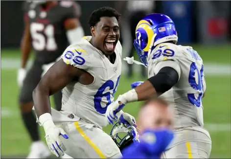  ?? AP Photo/Jason Behnken ?? Los Angeles Rams nose tackle Sebastian Joseph-Day (69) celebrates with defensive end Aaron Donald (99) after the team defeated the Tampa Bay Buccaneers during an NFL football game on Monday in Tampa, Fla.