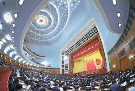  ?? JU PENG / XINHUA ?? Deputies participat­e in the second plenary meeting of the third session of the 13th National People’s Congress at the Great Hall of the People on Monday in Beijing.