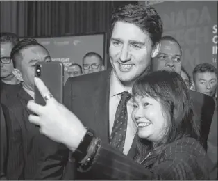  ?? CP PHOTO ?? Canadian Prime Minister Justin Trudeau poses for photos following a speech at a conference in Singapore Wednesday.