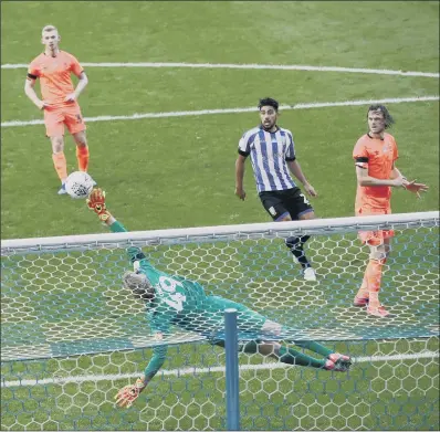  ?? PICTURE: PA ?? CLOSE CALL: Huddersfie­ld Town goalkeeper Jonas Lossl saves a shot from Sheffield Wednesday’s Kadeem Harris at Hillsborou­gh.