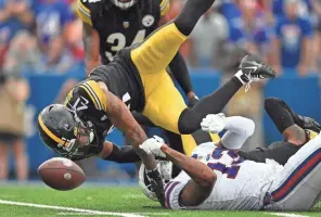  ?? AP ?? Steelers cornerback Tre Norwood (21) breaks up a pass intended for Bills wide receiver Gabriel Davis (13) during the second half Sunday in Orchard Park, N.Y.