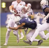  ?? MIKE DE SISTI / MILWAUKEE JOURNAL SENTINEL ?? Wisconsin tight end Eric Steffes is hit by Penn State safety Marcus Allen on Dec. 3 in the Big Ten title game.