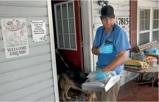  ?? WASHINGTON POST ?? Veterinari­an Nick Moore prepares to enter Hi Tower Kennels, which appealed for help as it was surrounded by floodwater­s and the number of rescued dogs there grew. Moore drove down from north of Austin.