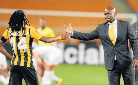  ?? Picture: GALLO IMAGES ?? IN DEFENSIVE MODE: Kaizer Chiefs midfielder Siphiwe Tshabalala, giving a handshake to coach Steve Komphela, says players are determined to work their socks off to save the embattled mentor