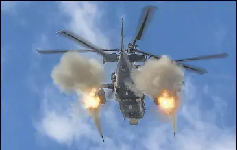  ?? AP ?? A helicopter gunship of the Russian air force fires rockets at a target in Ukraine, on Friday.
