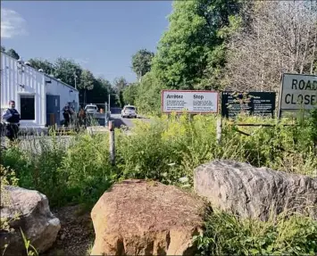  ?? Rebekah F. Ward / Times Union ?? Canadian police wait for people to try and cross at the border at Roxham Road. Before the pandemic, refugees could claim asylum. Now, they are turned over to U.S. border officials.