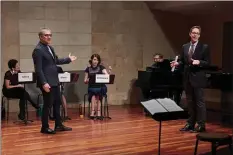  ?? MEROLA OPERA PROGRAM ?? Librettist Gene Scheer, left, and Jake Heggie stage a workshop of their new opera, “If I Were You,” with singers from the Merola Opera Program.