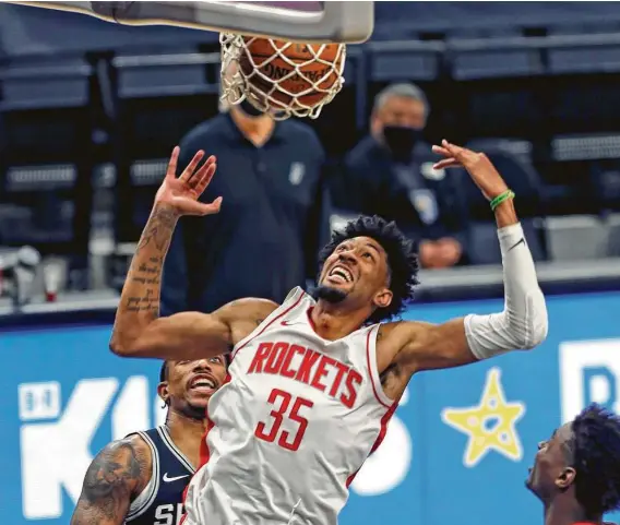  ?? Photos by Ronald Cortes / Getty Images ?? Christian Wood helped the Rockets get off to a good start in the post-James Harden era with 27 points and 15 rebounds Thursday night in a victory over the Spurs.