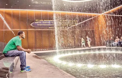  ??  ?? Wilson of Delaware, who was on his first visit to the National Museum of African American History and Culture, sits in the Contemplat­ive Court. The room, which features an indoor water cascade, has become a favorite spot in the museum for many. — WP-Bloomberg photos