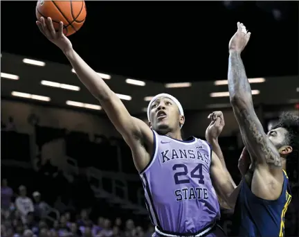  ?? ASSOCIATED PRESS FILE PHOTOS Feb. 14. ?? Kansas State guard Nijel Pack (24) shoots next to West Virginia forward Isaiah Cottrell during a game in Manhattan, Kan.,