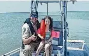  ?? Texas Parks and Wildlife Department ?? Texas game warden Ben Bailey, left, rescued a 6-year-old girl July 7 when her innertube drifted 1,200 yards from shore on Lavaca Bay.