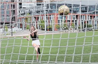  ?? RICHARD LAUTENS TORONTO STAR ?? Alexandra Karges kicks a soccer ball Wednesday on a public pitch in Toronto. Toronto has a love affair with soccer that shows in being a part of the North American winning FIFA World Cup 2026 bid.