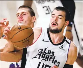  ?? I VICA ZUBAC, Mark J. Terrill Associated Press ?? battling’s Denver’s Nikola Jokic during the playoffs last season, will have to adjust to new teammates on the f loor when he comes off the bench.