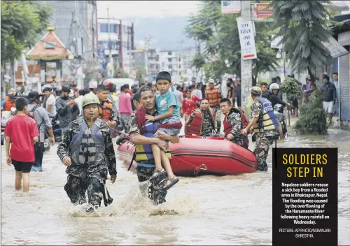  ??  ?? Nepalese soldiers rescue a sick boy from a flooded area in Bhaktapur, Nepal. The flooding was caused by the overflowin­g of the Hanumante River following heavy rainfall on Wednesday.